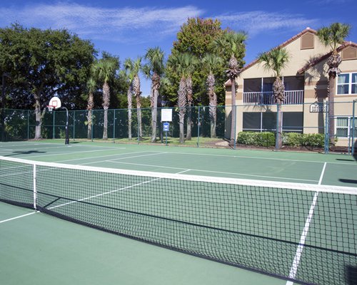 Outdoor recreation area with tennis court alongside a unit.