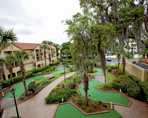 View of miniature golf courses alongside multi story resort units.