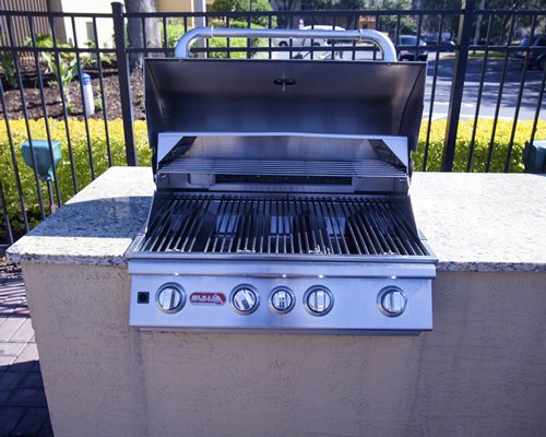 An outdoor barbecue grill with granite counter top.