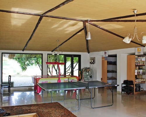 An indoor recreational area with a ping pong table.