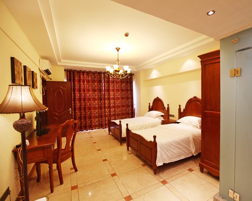 A well furnished bedroom with two twin beds.