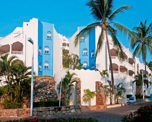 An exterior view of Gran Festivall Resort with trees.
