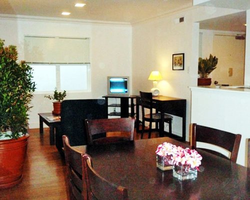 A well furnished living and dining area with a television.