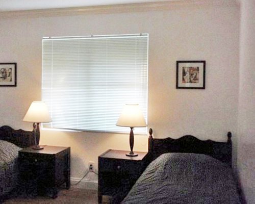 Bedroom with two twin beds and outside view.