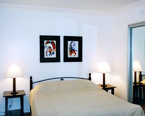 A well furnished bedroom with two lamps.