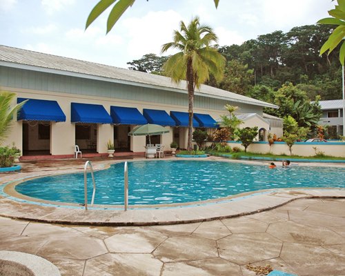 An outdoor swimming pool alongside resort units.
