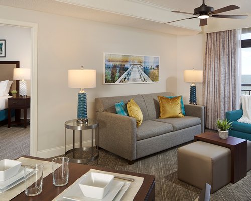 A well furnished living and dining area with a television and a balcony with patio.