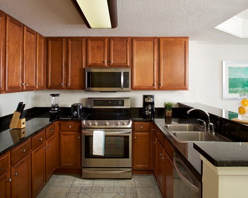 A well furnished living room and an open plan kitchen with dining area.
