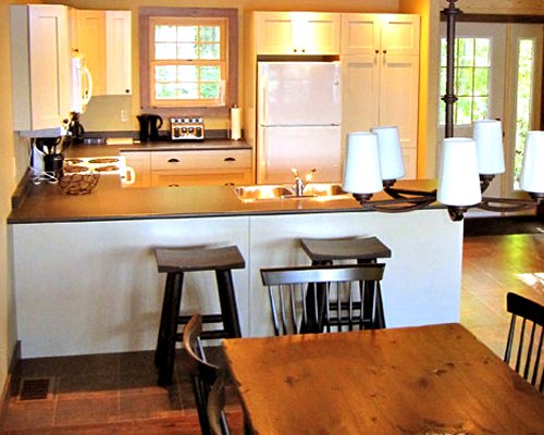 An open plan kitchen with a breakfast bar and dining area.
