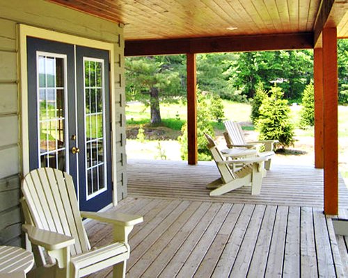A recreation area with patio furniture alongside the trees.