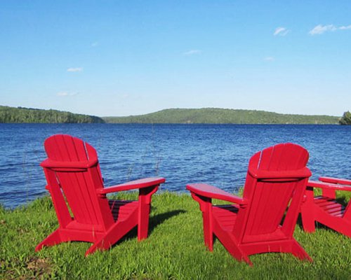 View of chaise lounge chairs facing the lake.