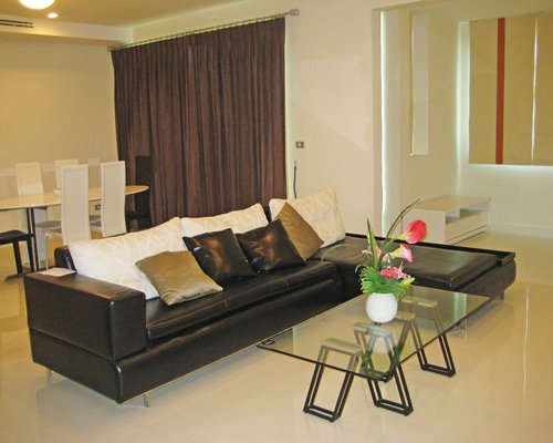 A well furnished living room with a dining area.