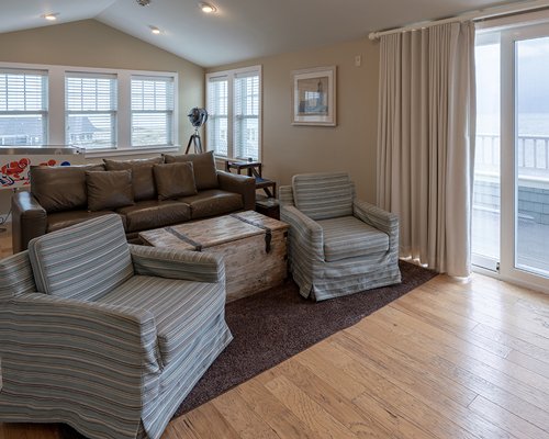 A well furnished bedroom with a pull out sofa and television.