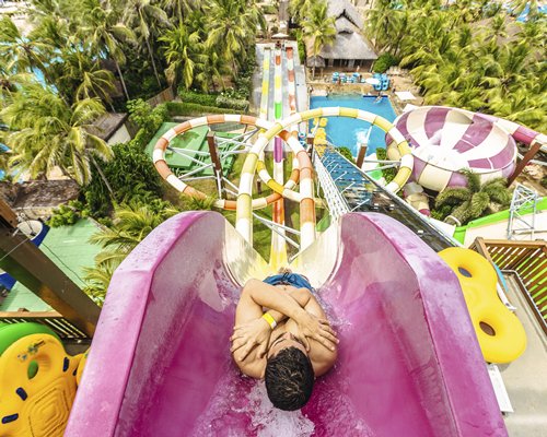 An outdoor swimming pool with water slides.