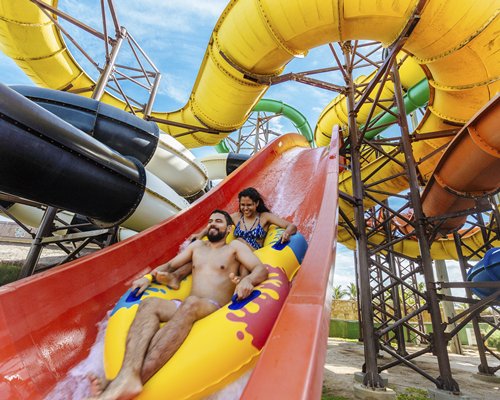Two people going on water slides.