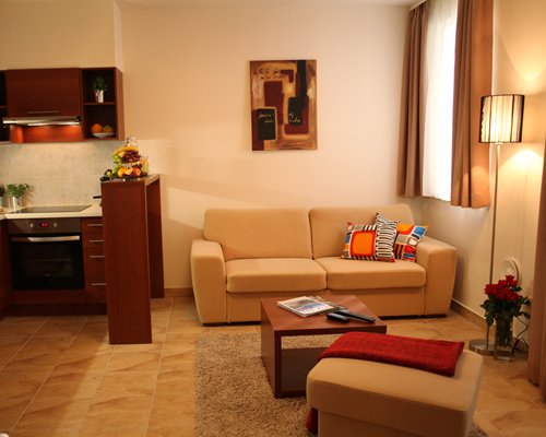 A well furnished living room with an open plan kitchen.