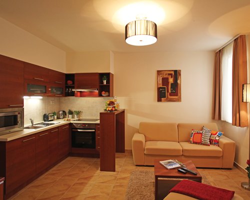 A well furnished living room with an open plan kitchen.