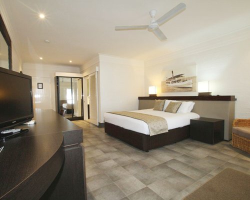 A well furnished bedroom with a television.
