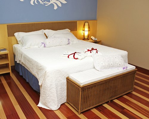 A well furnished bedroom with a lamp.