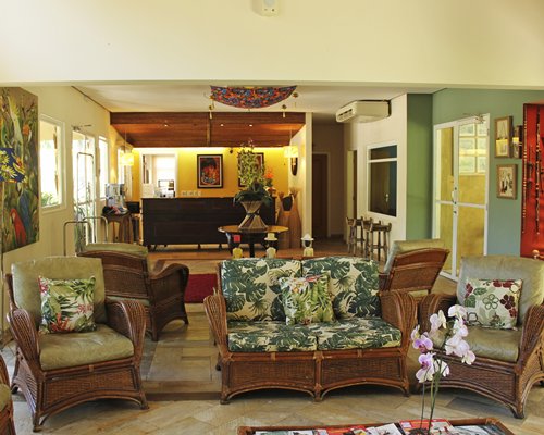 A well furnished living room with an open plan kitchen and outside view.