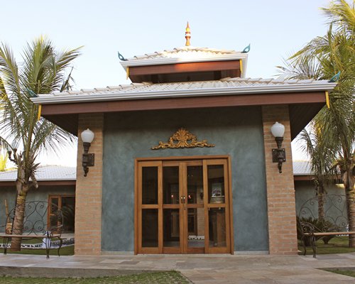 An exterior view of a resort unit alongside trees.