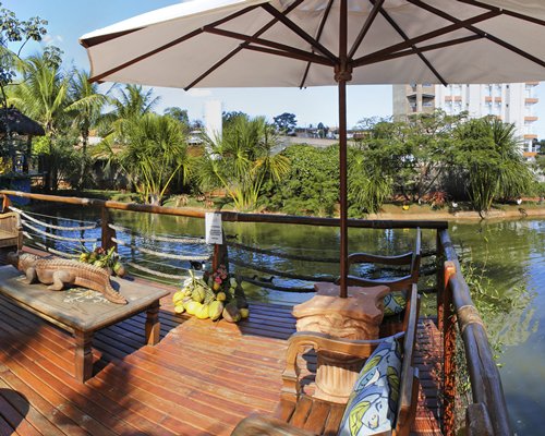 An outdoor picnic area with sunshade alongside the waterfront.