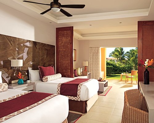A well furnished bedroom with two beds and an outside view.