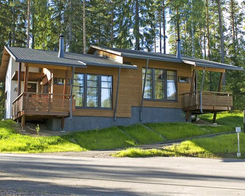 Street view of a resort unit surrounded by trees.