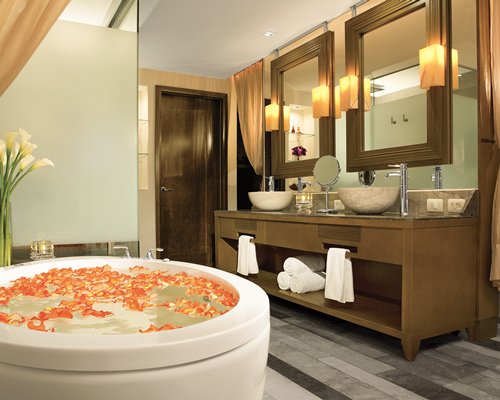 A bathroom with double sink open vanity and a bathtub.