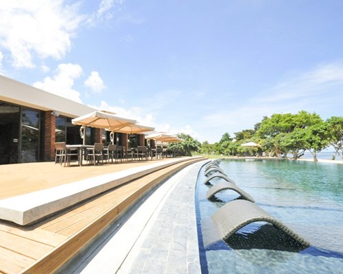 An outdoor swimming pool alongside resort units.