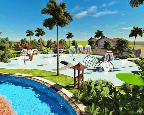 An outdoor kiddie pool with fountain alongside a lazy pool.