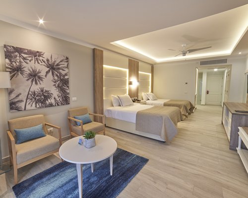 A well furnished living room with a two beds.