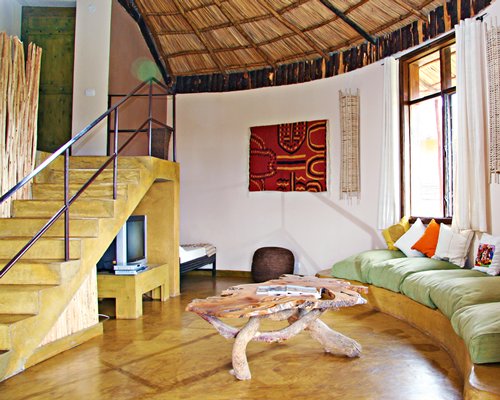 A well furnished living room with a television and stairway.