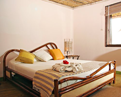 A well furnished bedroom with an outside view.