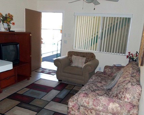 A well furnished living room with a pull out sofa and television.