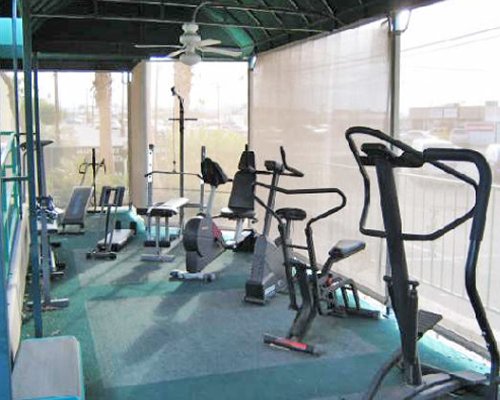 A well equipped indoor fitness center with outside view.