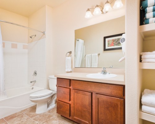 A BATHROOM WITH SHOWER BATHTUB AND CLOSED SINK VANITY.
