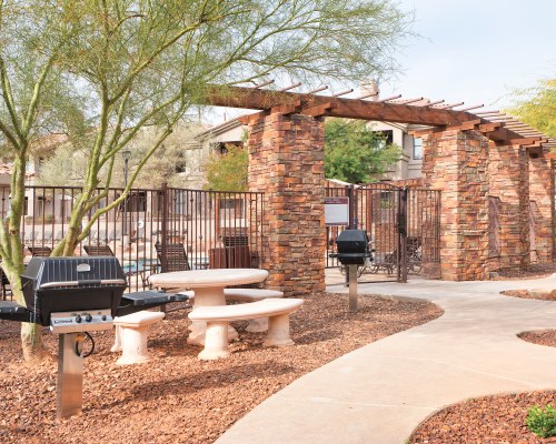 AN OUTDOOR PICNIC AREA WITH BARBECUE GRILLS.