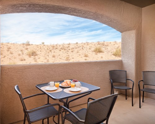 BALCONY WITH DINING AREA AND AN OUTSIDE VIEW.
