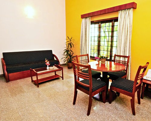 A well furnished living room with dining area and an outside view.