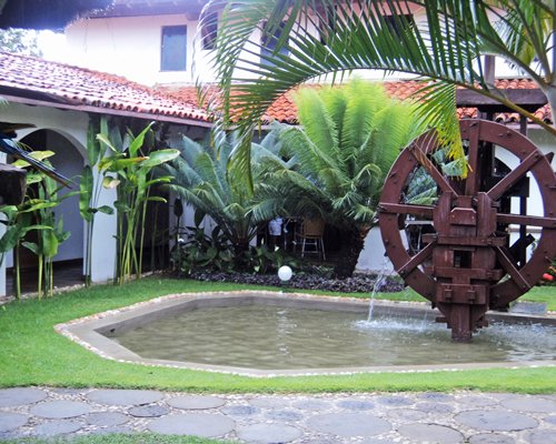 A water wheel alongside the resort unit.