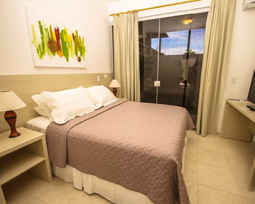A well furnished bedroom with an outside view.