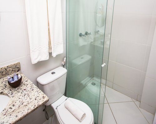 A bathroom with a sink and shower stall.