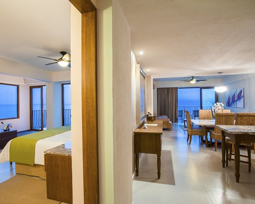 A well furnished dining area with breakfast bar and bedroom.