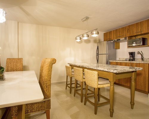 An open plan kitchen and dining area with a breakfast bar.