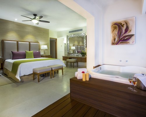 A well furnished bedroom with a bathtub.