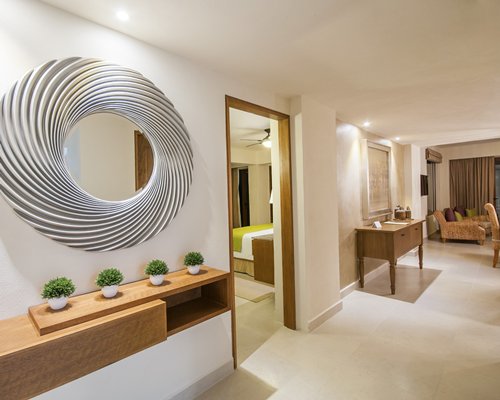 Living area with a bedroom and vanity.