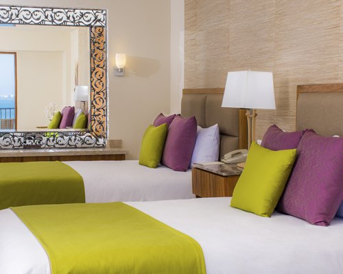 A well furnished bedroom with two beds.