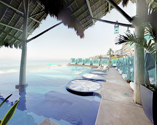 An outdoor swimming pool with hot tubs.