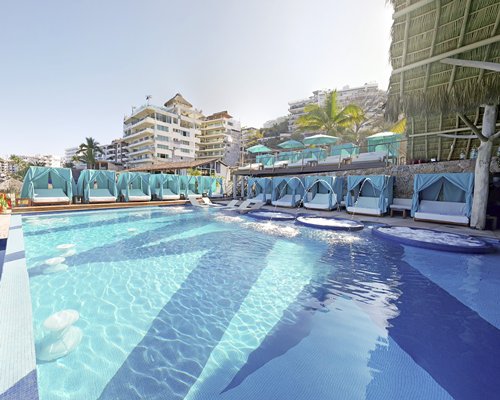 An outdoor swimming pool with beach beds.